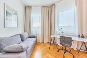 a living room with a couch and a table and two windows at Lisa 3, Guestroom-WG-Zimmer Eggert in Pforzheim