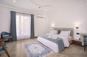 a bedroom with a large bed and a window at Hasthri Boutique Blue Apartment in Ahangama with pool Near Beach in Ahangama +24 photos