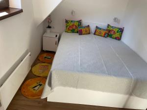 a bed in a small room with a white bed frame at Apartments Sia-M3 in Kopaonik