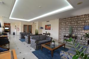 a living room with couches and a table at Hotel The Brand in Rome