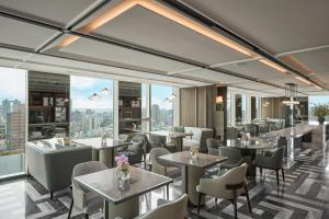a restaurant with tables and chairs and large windows at InterContinental Taichung by IHG in Taichung