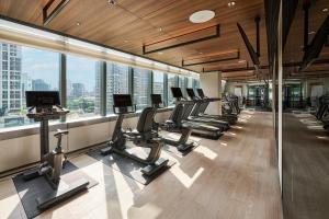 a gym with a row of treadmills and machines at InterContinental Taichung by IHG in Taichung