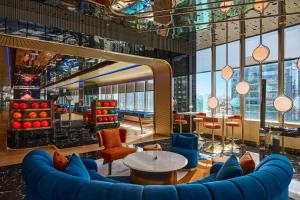 a lobby with a blue couch and a table at InterContinental Taichung by IHG in Taichung