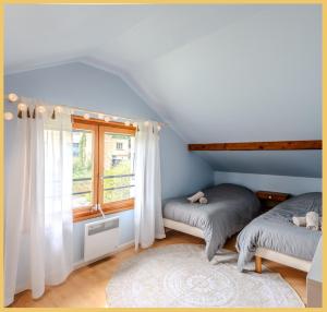 ein Schlafzimmer mit zwei Betten und einem Fenster in der Unterkunft La Maison du Lac I Excenevex in Excenevex