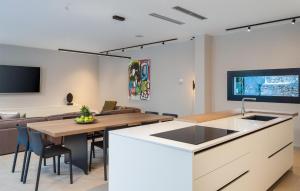 a kitchen and living room with a table and a couch at Villa Amber in Pakoštane