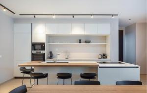 a kitchen with a large island with black stools at Villa Amber in Pakoštane