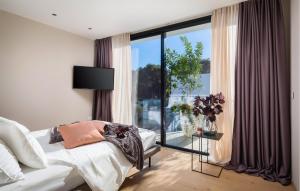a bedroom with a bed and a large window at Villa Amber in Pakoštane +26 photos