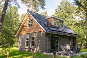 a tiny house with a gambrel roof at RCN het Grote Bos in Doorn