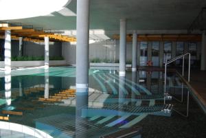 an empty swimming pool with stairs in a building at Domki Kuter Port in Gdów
