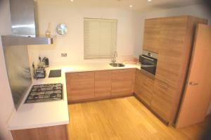 a kitchen with a sink and a stove top oven at Brentwood Town Retreat - Large 2 bedroom apartment in Brentwood