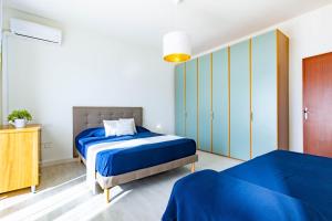 ein Schlafzimmer mit zwei Betten und einer Kommode in der Unterkunft Appartamento Bellariva D2 - MyHo Casa in Porto San Giorgio