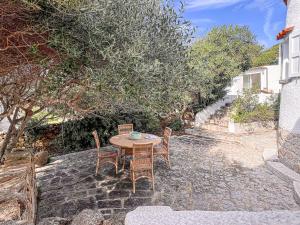 a table and chairs sitting on a stone patio at Villa Adea in Santa Teresa Gallura