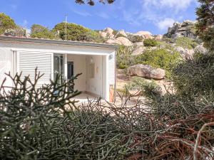 a small white building in the middle of a mountain at Villa Adea in Santa Teresa Gallura +23 photos