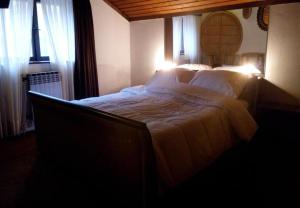 Un dormitorio con una cama grande con sábanas blancas. en Rooms Branka, en Križevci