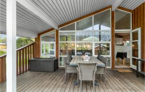 a patio with a table and chairs on a deck at Holiday Home Boeslumvej in Ebeltoft +25 photos