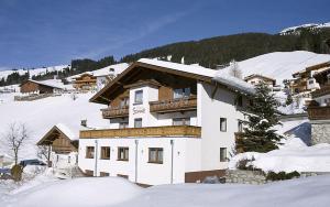 a large building with snow on top of it at Hotel Sonne in Tux