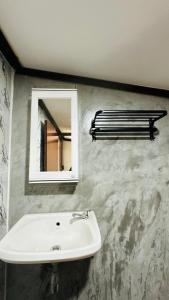 a bathroom with a white sink and a mirror at Lanta L.D. Beach Bungalow in Ko Lanta +139 photos