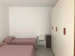 Ένα ή περισσότερα κρεβάτια σε δωμάτιο στο Casa Vacanze Dionisia