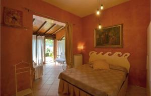 a bedroom with orange walls and a bed in a room at Lovely Home In Cortona With Kitchen in Cortona