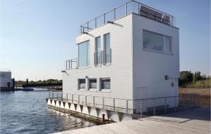 a house on a dock on a body of water at Captain Jack Sparrow in Olpenitz