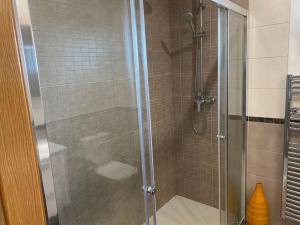 a shower with a glass door in a bathroom at El Valles Apartment sea view in Llança +59 photos