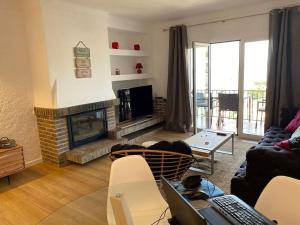 a living room with a couch and a fireplace at El Valles Apartment sea view in Llança