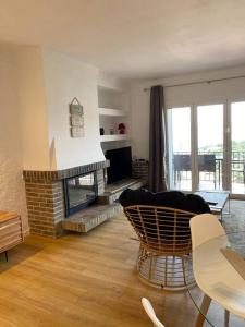 a living room with a couch and a fireplace at El Valles Apartment sea view in Llança