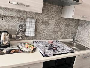 a kitchen with a sink and a counter top at Tarantè Apartment in Naples