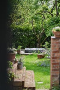 a garden with a bench and a bed in the background at Casa Vacanze Černovice in Černovice +12 photos
