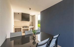 a kitchen and dining room with a table and chairs at Amazing Home In Pasman in Živica