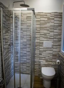 a bathroom with a shower and a toilet at Il Piccolo Attico comfort house in Viterbo +13 photos