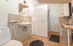 a bathroom with a toilet and a sink at Five-Bedroom Holiday Home In Hojby in Højby