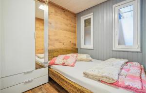a small bedroom with a bed and two windows at Beautiful Home In Zeulenroda-Triebes in Stelzendorf