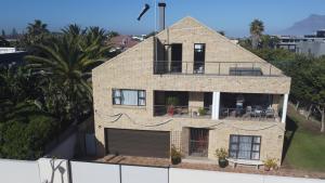 a brick house with a balcony on top of it at Clearwater view in Cape Town
