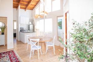 a kitchen and dining room with a wooden table and chairs at Bushman Valley in Prince Albert