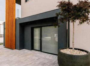 a building with a large door with a tree in it at Luxury Contemporary Villa in Vodice with Pool, Sauna and Hot Tub in Vodice