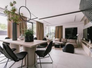 a living room with a table and chairs at Luxury Contemporary Villa in Vodice with Pool, Sauna and Hot Tub in Vodice +45 photos