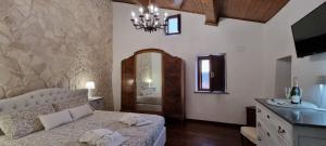 a bedroom with a large bed and a mirror at La casa di Agnese in Fiuggi