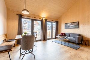 a living room with a couch and a table at Apartments Kreischberg Chalets by ALPS RESORTS in Sankt Lorenzen ob Murau