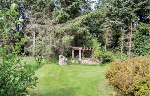 a garden with a structure in the middle of a field at Holiday Home Hyttefadet in Lønstrup