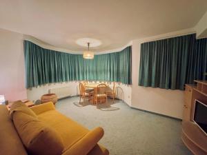a living room with a couch and a table at Appartement Davis-Birkl in Sankt Anton am Arlberg +14 photos