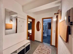 a hallway with a room with a mirror at Appartement Davis-Birkl in Sankt Anton am Arlberg