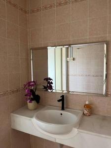 a bathroom with a sink and a mirror at The White House Nilai Impian in Nilai