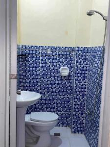 a bathroom with a sink and a toilet and a shower at Friz Love Room Rental in San Juan +50 photos
