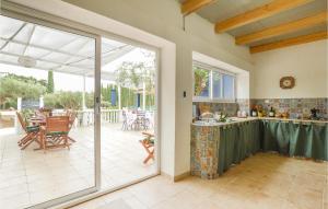 a kitchen with a sliding glass door leading to a patio at Beautiful Home In Menfi in Menfi