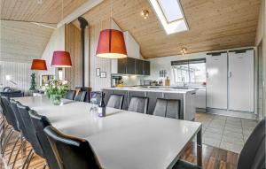 a kitchen and dining room with a table and chairs at Awesome Home In Idestrup With Kitchen in Marielyst
