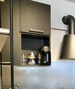 a kitchen with a counter top with a clock andartifacts at Marty's House in Arezzo