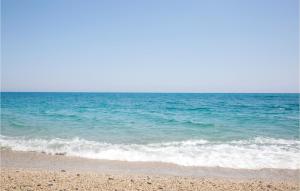 a sandy beach with the ocean in the background at Gorgeous Home In Piano Di Mommio in Piano di Mommio
