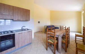 a kitchen with a table and a sink and a stove at Amazing Home In Melito Porto Salvo in Melito di Porto Salvo
