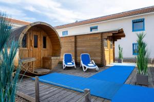 a house with two chairs and a yoga mat on a deck at Sunday Hotel and Spa Wismar in Wismar +36 photos